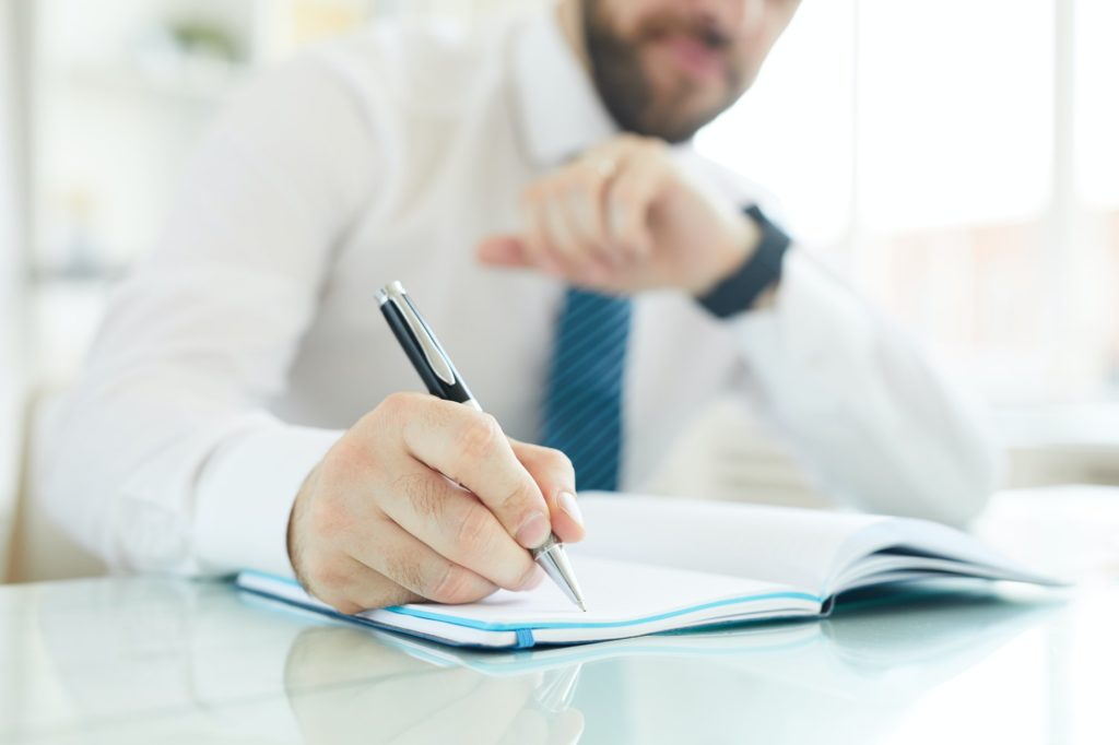 Businessman scheduling day in office